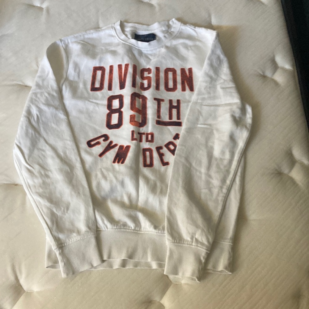 White crew neck with orange writing